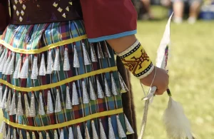 closeup view of a young indigenous person wearing a jingle dress